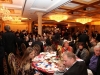 busy banquet hall with guests seated at round dinner tables