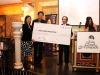 three people on award stage holding giant sized check for Jean Lumb Foundation from RBC