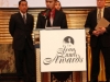 young man standing at podium with sign reading Jean Lumb awards