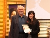young women holding award standing next to man