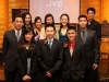 students grouped together for photo in front of stage