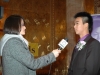 Young man being interviewed by reporter  holding microphone