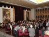 large banquet hall full of people sitting at round tables