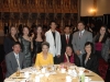 group of attendess gathered round banquet table for a photo