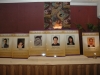 photos of Jean Lumb alumni displayed on long table