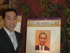 Jean Lumb alumnus posing next to his protrait