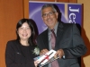 man handing off award to student