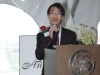 student behind podium speaking to guests