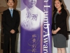 two students standing on either side of the Jean Lumb banner