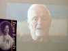 man speaking from projected film