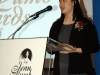 women speaking from behind podium