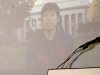 young man speaking on large projector