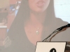 young women speaking on large projector screen