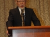 man speaking behind podium