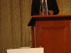 man speaking behind podium