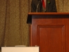 man speaking behind podium