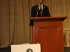 man speaking behind podium