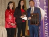 three people standing for photo holding their awards