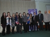 Group standing together beside Jean Lumb banner