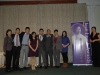 Group standing together beside Jean Lumb banner