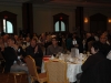 Large banquet hall with guests seated at dinner tables