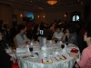 Large banquet hall with guests seated at dinner tables