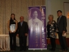 Group standing together beside Jean Lumb banner