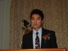 Man speaking behind podium.