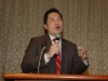 man speaking behind microphone