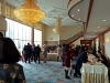 Lobby full of guest registering at long table.