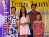 Four of Jean Lumb's grandchildren standing on stage.