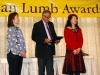 three people waiting to present awards.