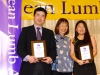 Students holding their award plaques.