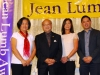 Four people posing under Jean Lumb sign.