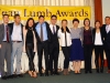 Group of people posing under Jean Lumb sign.