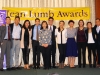 Group of people posing under Jean Lumb sign.