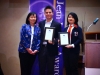 Two students holding their award plaques next to Arlene Chan.