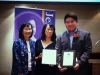 Students holding their award plaques.