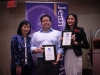 Students holding their awards in front of Jean Lumb banner.