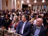 Row of guests seated to watch award presentation.