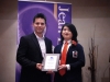 Student being handed award plaque.