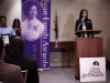 Women speaking at podium.