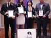 Students holding their awards behind Jean Lumb sign.