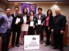 Students holding their awards behind Jean Lumb sign.