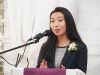 student speaking into microphone behind podium.