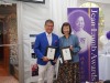 winners holding award plaques next to Jean Lumb banner.