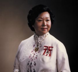 formal protrait of Jean Lumb facing front. wearing a white dress and the Order of Canada pin on her left.