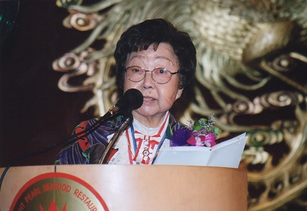 Jean Lumb speaking at podium